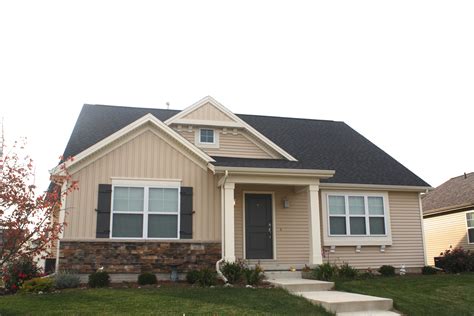 tan siding black roof